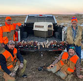 Four men and a truck after a day of hunting. 